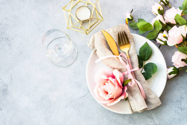 istock Table setting with white plate, cutlery and flowers. 1987874401