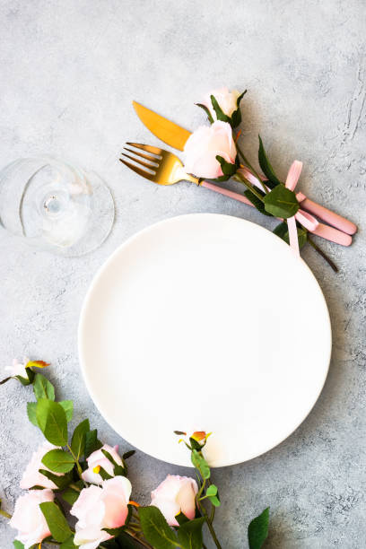 istock Table setting with white plate, cutlery and flowers. 1987874925