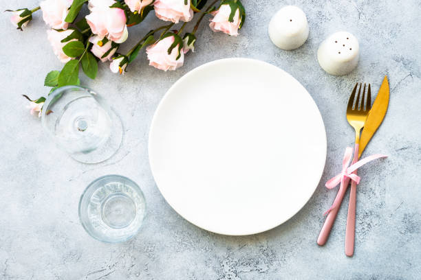istock Table setting with white plate, cutlery and flowers. 1987874932