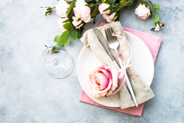 istock Table setting with white plate, cutlery and flowers. 1987875445