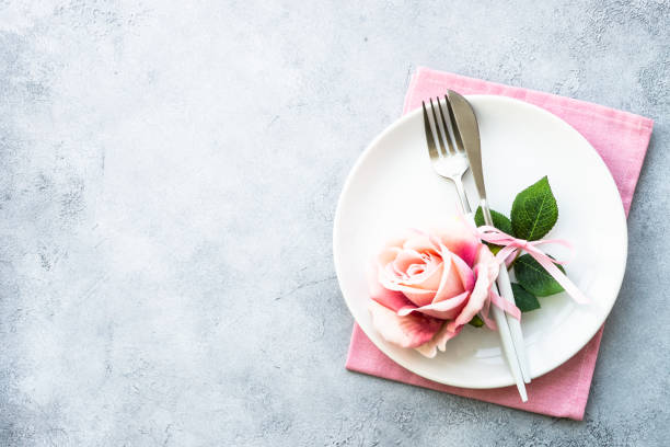 istock Table setting with white plate, cutlery and flowers. 1987875451