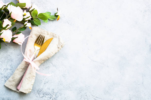 istock Table setting with modern cutlery and rose flowers. 1987876521