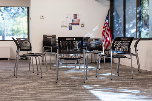 The empty room in the family services building has chairs set up in a circle ready for the support group meeting.