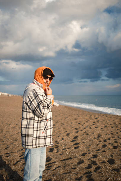 A man resisting the difficulties of life by the sea