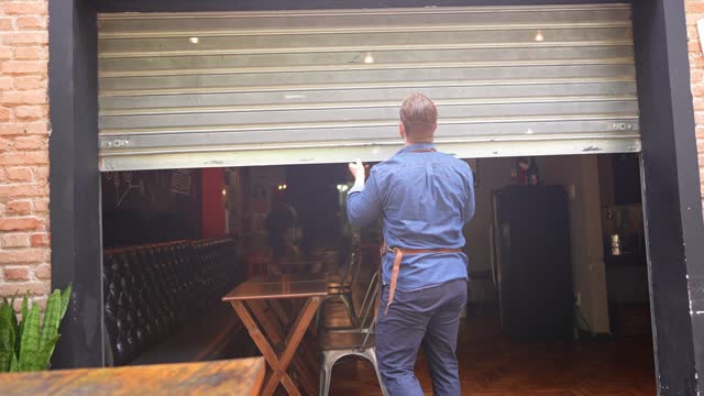 Owner man opening the door of his coffee shop