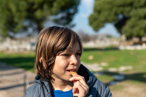 istock little boy eats crackers in the park 1987930836