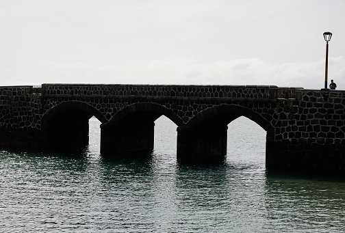 Arrecife (Spain), January 18, 2024. The Ball bridge was built to defend the capital of Lanzarote from pirates. It owes its name to the two stone balls on the columns