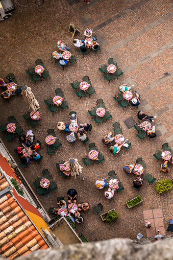 Riva del Garda, Italy - October, 4. 2023: Looking down to a street cafe at a town square in Riva del Garda downtown.