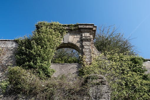 Stone archway overgrown architecture abandoned in Italy