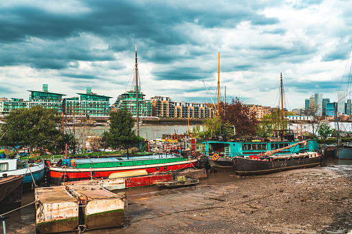 Boats moored near Tower Bridge on the River Thames, London