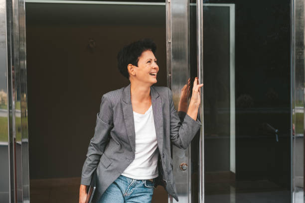 istock Happy Woman Exiting Building 1987983704