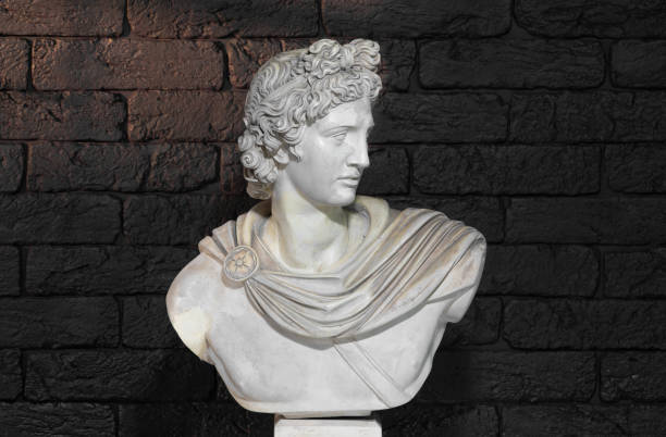 istock Apollo head sculpture isolated on black background 1987997351
