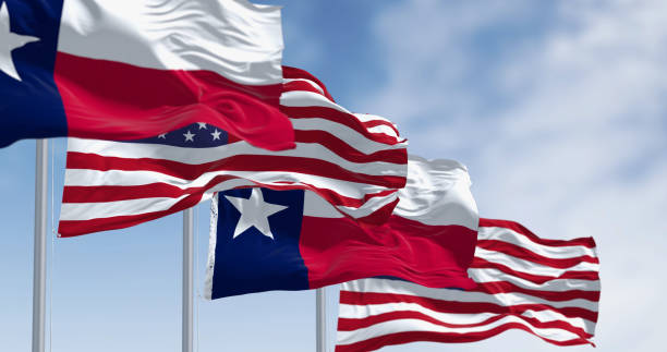 istock Texas state flags waving in the wind with american flags 1988006748