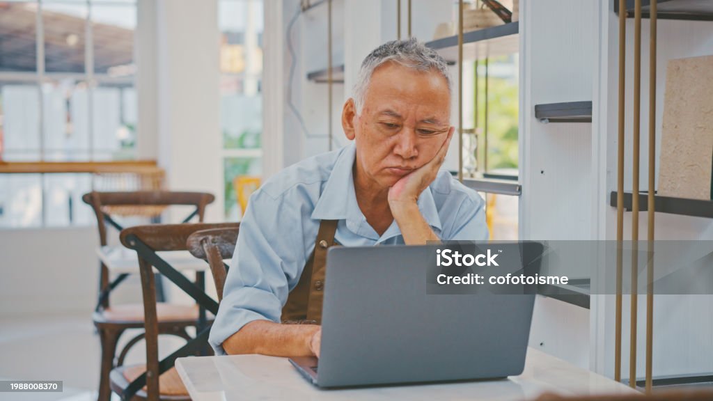 Senior Confused Using Computer Senior Man Confused While Using Computer In His Coffee Shop Stock Photo ...