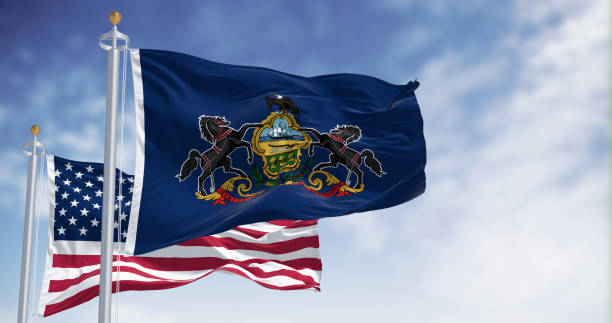 istock Pennsylvania state flag waving with the american flag 1988009417