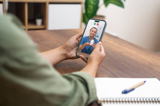 istock Video conferencing with a friendly doctor presenting medication during an online consultation 1988025611