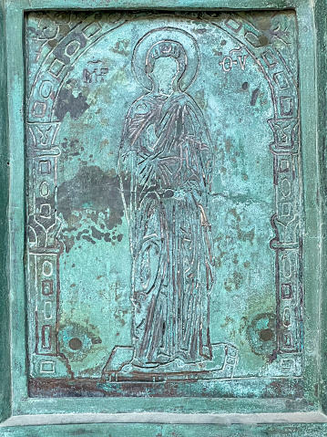 Salerno, Italy, September 26, 2023: Cathedral of Saint. Matthew in Salerno, Italy. Fragment of an antique door depicting figures of saints.