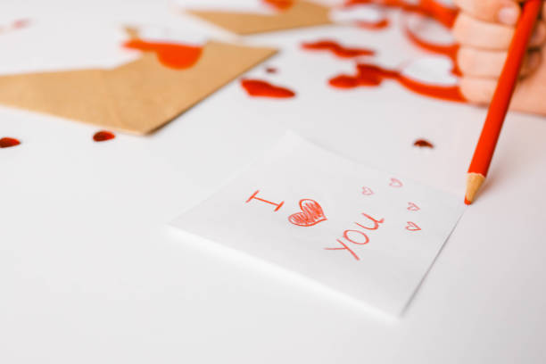 A pair of hearts drawn by a red lipstick on a lined notepad page. Space for copy.