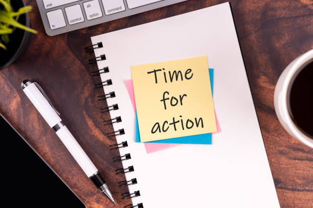 istock Sticky note with text Time for action on top of desk 1988034588