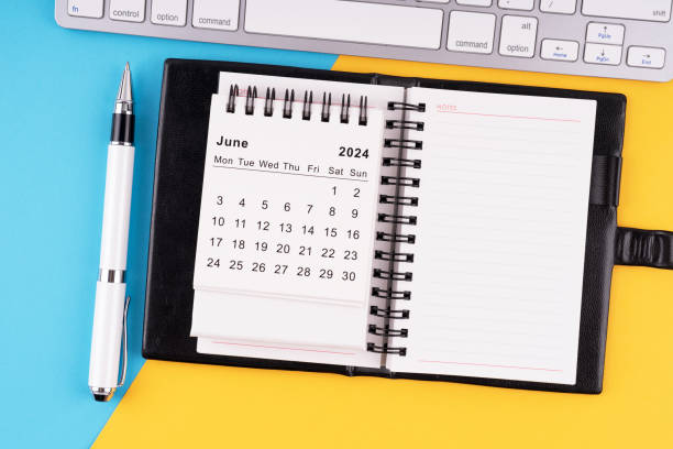 istock June 2024 calendar, notepad, pen and computer keyboard 1988034589