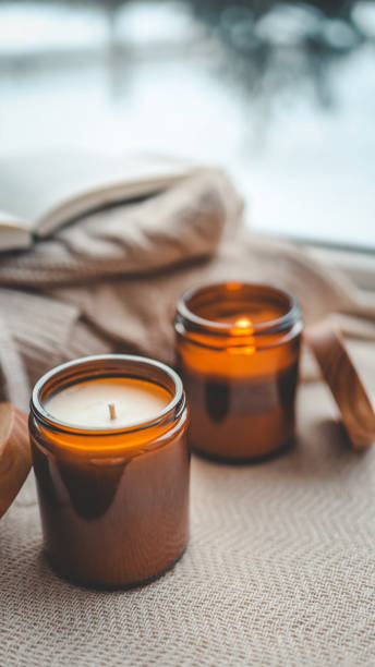 istock Burning candle in a cozy home interior 1988046222