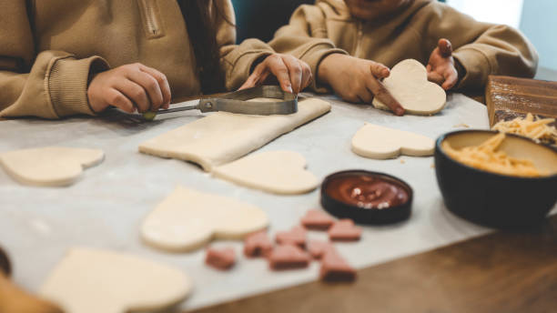 istock Children making pizza in the kitchen 1988047278