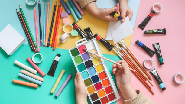 istock Back to school. Panoramic education banner. Top view, flat lay. Colorful supplies on table, colored paper. Children's creativity concept. Preschool study, development. Accessories for the schoolroom 1988050436