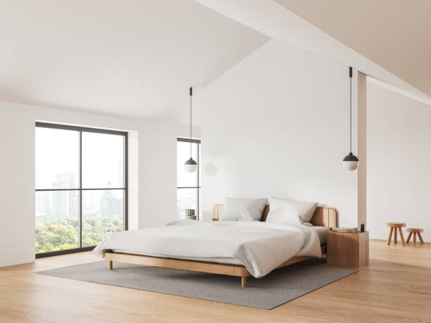 istock Modern home bedroom interior with bed and panoramic window. Mock up wall 1988067062