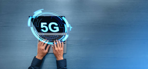 istock Top view of man hands with laptop, 5G glowing icon internet network 1988074628