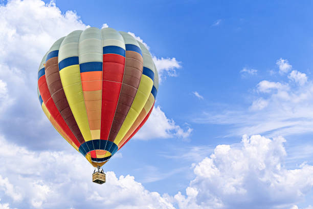 istock Hot air balloon flight over blue sky 1988076151