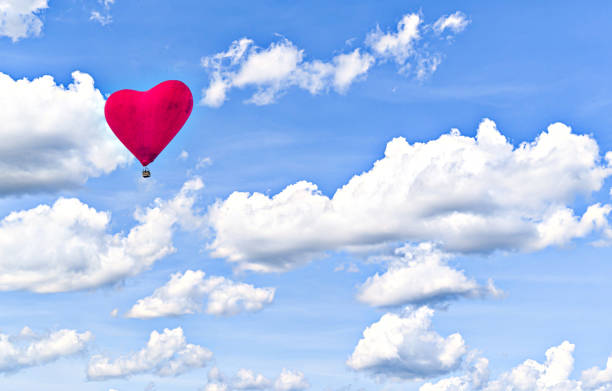 Heart shaped balloon rising into the sky