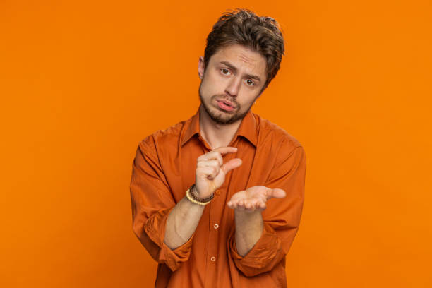 istock Man show a little bit gesture, begging help, need some more, please give me measuring small size 1988077848