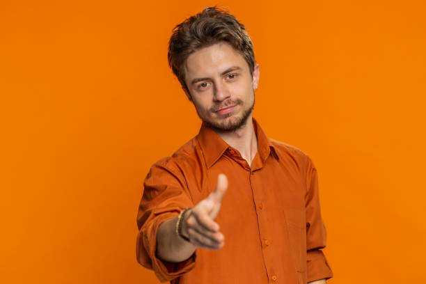 istock Caucasian man outstretching hand to camera offering handshake greeting invitation welcoming 1988078377
