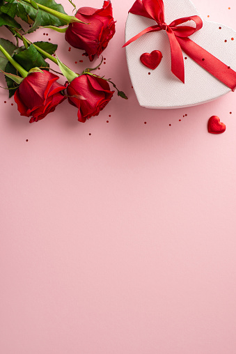 Picture-perfect woman's festive notion. Vertical top view capture of sumptuous floral arrangement, snazzy heart box, decoration, shimmer on pink base, including spot for personalized text or marketing