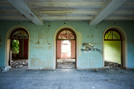 old dirty soviet entrance in an apartment building after a fire, a corridor in the entrance, a staircase