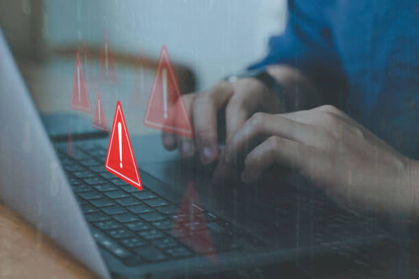 istock Emergency warning alert alarm on computer, Data network protection, Virus alarm with people using application on smartphone. 1988099086