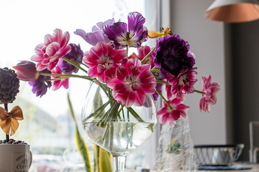 A multicolored bouquet of flowers in an outdoor cafe