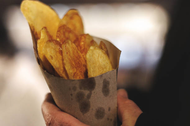 French fries stuffed inside a cardboard cone bought at a fair in Spain