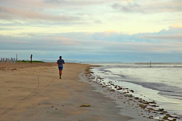 istock Early morning on the beach, exercising on the sand 1988141875