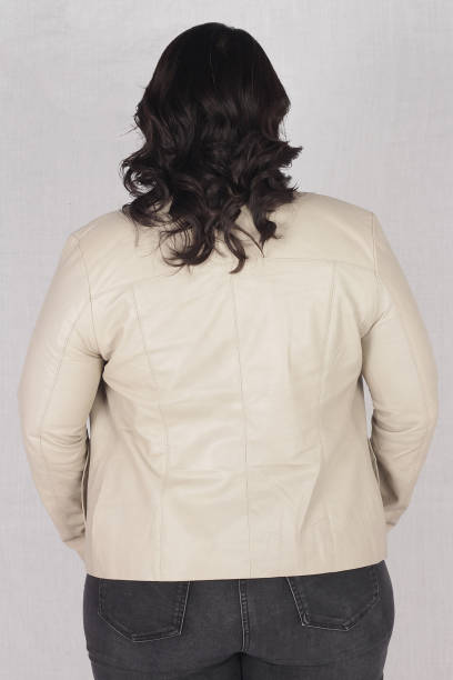 istock Female model posing in white jacket and black jeans 1988156020