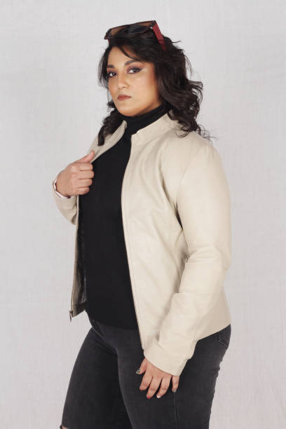 istock Female model posing in white jacket and black jeans 1988156535