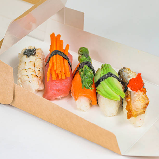 istock Box Filled With Sushi and Vegetables on Table 1988161252