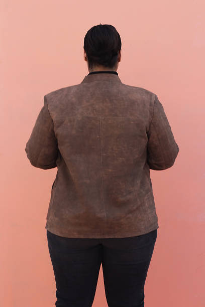 A woman in brown Leather jacket and black top