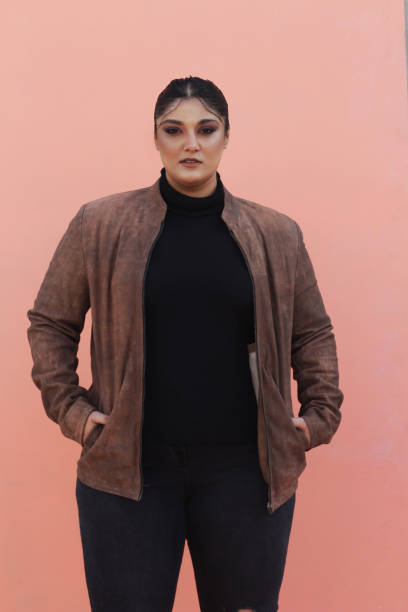 istock A woman in brown Leather jacket and black top 1988189606