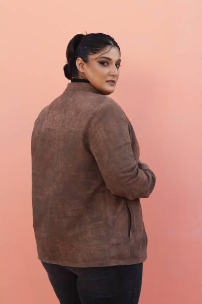 A woman in brown Leather jacket and black top