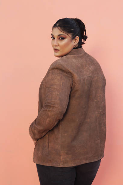 istock A woman in brown Leather jacket and black top 1988190128