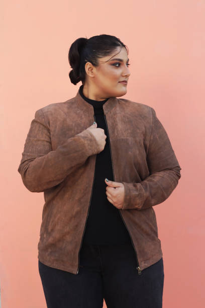 istock A woman in brown Leather jacket and black top 1988191206