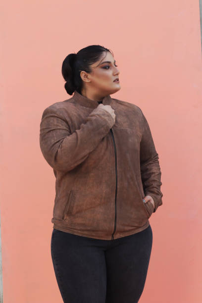 istock A woman in brown Leather jacket and black top 1988191414
