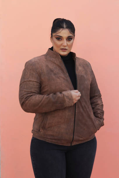 istock A woman in brown Leather jacket and black top 1988191733