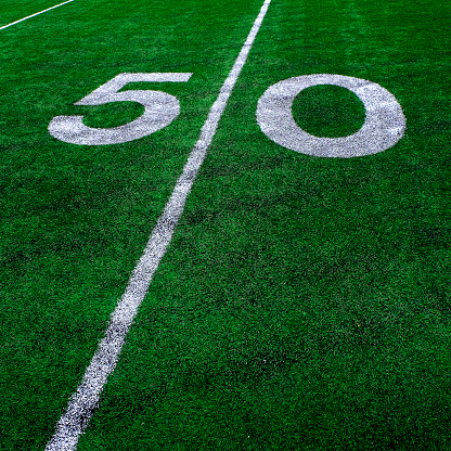 Football field green grass white yard markers to touchdown competition game